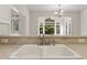 Kitchen sink with view to backyard, plus white cabinets and hardware at 1250 Parkview Nw Ln, Kennesaw, GA 30152