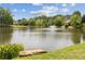 Picturesque lake view featuring a fountain, lush trees, and well-maintained landscaping at 1250 Parkview Nw Ln, Kennesaw, GA 30152