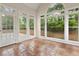 Sunroom boasts tile flooring and a full wall of windows and a french door, perfect for enjoying the view at 1250 Parkview Nw Ln, Kennesaw, GA 30152