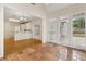 A sunroom with tile floors connects to the kitchen with hardwood floors and white cabinets at 1250 Parkview Nw Ln, Kennesaw, GA 30152