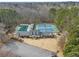 Aerial view of the community center featuring pool, tennis courts, playground, and clubhouse nestled among mature trees at 1508 Walker Ridge Sw Dr, Marietta, GA 30064
