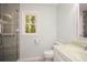 Modern bathroom with glass enclosed shower, window, and sink with white cabinetry at 1508 Walker Ridge Sw Dr, Marietta, GA 30064