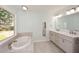 Bright bathroom boasts double vanities, a soaking tub, and a large window at 1508 Walker Ridge Sw Dr, Marietta, GA 30064