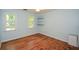 Bedroom with wood flooring, built-in shelves, and bright windows at 1508 Walker Ridge Sw Dr, Marietta, GA 30064