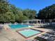 Sparkling community pool and hot tub with lounge chairs and shaded seating area, perfect for relaxation and socializing at 1508 Walker Ridge Sw Dr, Marietta, GA 30064