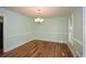 Formal dining room with hardwood floors, chair railing, and a modern chandelier at 1508 Walker Ridge Sw Dr, Marietta, GA 30064