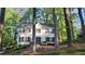 Charming white two-story home with black shutters surrounded by lush trees at 1508 Walker Ridge Sw Dr, Marietta, GA 30064