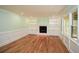 Cozy living room with hardwood floors, built-in bookshelves, and a fireplace at 1508 Walker Ridge Sw Dr, Marietta, GA 30064