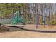 A community playground with a slide and swing set surrounded by mature trees and a grassy lawn at 1508 Walker Ridge Sw Dr, Marietta, GA 30064