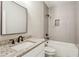 A modern bathroom showcasing a granite-topped vanity and tile-surround shower-tub combination at 1701 Aircraft S Dr, Marietta, GA 30060