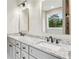 Elegant bathroom with double sinks, granite countertops, large mirrors, and modern hardware at 1701 Aircraft S Dr, Marietta, GA 30060