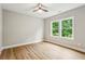 An empty bedroom with light-filled windows, ceiling fan, and wood-look flooring at 1701 Aircraft S Dr, Marietta, GA 30060