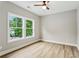 A sun-filled bedroom featuring stylish plank floors and bright windows overlooking the backyard at 1701 Aircraft S Dr, Marietta, GA 30060