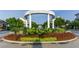 Welcome to Smyrna Market Village, an inviting community entrance with manicured landscaping and brick paved drive at 1701 Aircraft S Dr, Marietta, GA 30060
