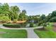 Scenic community pond featuring a water fountain, surrounded by lush greenery and walking paths at 1701 Aircraft S Dr, Marietta, GA 30060