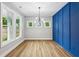 Elegant dining room with stylish light fixture and blue accent wall at 1701 Aircraft S Dr, Marietta, GA 30060