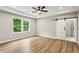 Spacious main bedroom with a modern ceiling fan, natural light and a sliding barn door to the bathroom at 1701 Aircraft S Dr, Marietta, GA 30060