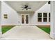 Covered patio with ceiling fan leading to a fenced-in backyard with white siding on the home at 1701 Aircraft S Dr, Marietta, GA 30060
