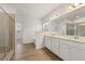 Bathroom featuring double sinks, a glass shower, and wood-look floors at 321 Arwen Dr, Mcdonough, GA 30252