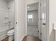 Bright bathroom with a shower and a doorway to a carpeted room at 321 Arwen Dr, Mcdonough, GA 30252