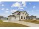 The two car garage and wide drive are displayed at 321 Arwen Dr, Mcdonough, GA 30252