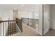 Hallway with carpet, wood railing, an open door and neutral paint at 321 Arwen Dr, Mcdonough, GA 30252