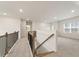 Hallway with carpet, wood railing and neutral paint throughout at 321 Arwen Dr, Mcdonough, GA 30252