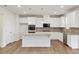 Open-concept kitchen features an island and stainless steel appliances at 321 Arwen Dr, Mcdonough, GA 30252
