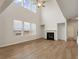 The living room features high ceilings, large windows, and a cozy fireplace at 321 Arwen Dr, Mcdonough, GA 30252