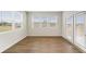 Living room features three large windows and a door leading to outdoors at 321 Arwen Dr, Mcdonough, GA 30252