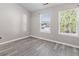Bedroom with lots of natural light and gray hardwood flooring at 6099 Camden Forrest Cv, Riverdale, GA 30296
