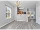 Dining room with hardwood floors, open to the kitchen with an adjacent patio door at 6099 Camden Forrest Cv, Riverdale, GA 30296
