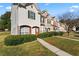 Row of townhomes each with a manicured lawn and sidewalk to the front doors at 6099 Camden Forrest Cv, Riverdale, GA 30296