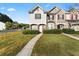 Charming townhome featuring a well-maintained lawn and inviting entryway at 6099 Camden Forrest Cv, Riverdale, GA 30296