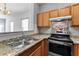 Kitchen view features granite countertops, stainless steel appliances and bright lighting at 6099 Camden Forrest Cv, Riverdale, GA 30296