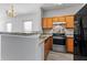Kitchen featuring a breakfast bar, granite counters and stainless appliances at 6099 Camden Forrest Cv, Riverdale, GA 30296