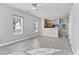 Open-concept living area showcasing contemporary flooring and modern light fixture at 6099 Camden Forrest Cv, Riverdale, GA 30296