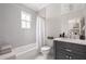 Bright bathroom with subway tile, dark vanity, and shower-tub combination at 132 Mount Vernon Dr, Decatur, GA 30030
