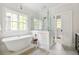 Bright bathroom featuring a soaking tub, walk-in shower, and white subway tile at 132 Mount Vernon Dr, Decatur, GA 30030