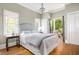 Serene bedroom with French doors opening to an outdoor deck and a decorative chandelier at 132 Mount Vernon Dr, Decatur, GA 30030