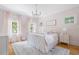 Charming bedroom featuring a white iron bed frame and pink accents with hardwood floors at 132 Mount Vernon Dr, Decatur, GA 30030