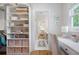 Organized closet with built-in shelving and a desk area in a bright space at 132 Mount Vernon Dr, Decatur, GA 30030