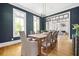 Dining room with hardwood floors, white trim, large windows, and stylish light fixture at 132 Mount Vernon Dr, Decatur, GA 30030