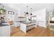 Bright kitchen with island, stainless steel appliances, white cabinets, and hardwood floors at 132 Mount Vernon Dr, Decatur, GA 30030