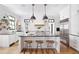 Open-concept kitchen with island, stainless steel appliances, white cabinets, and barstool seating at 132 Mount Vernon Dr, Decatur, GA 30030