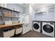 Efficient laundry room with sink, shelving, and modern washer and dryer at 132 Mount Vernon Dr, Decatur, GA 30030