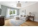 Bright sitting room features a comfortable white couch, natural light, and neutral decor at 132 Mount Vernon Dr, Decatur, GA 30030