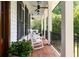 Inviting covered porch with wood floors, rocking chairs, ceiling fans, and black railing detail at 132 Mount Vernon Dr, Decatur, GA 30030
