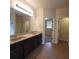 Spacious bathroom with a dual sink vanity and tile floor with a shower in the background at 1474 Union Station, Lawrenceville, GA 30045