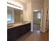 Spacious bathroom with a dual sink vanity and tile floor with a shower in the background at 1474 Union Station, Lawrenceville, GA 30045